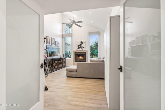 living room featuring vaulted ceiling, ceiling fan, and light hardwood / wood-style floors