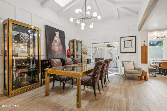 dining room featuring a chandelier, beam ceiling, light hardwood / wood-style flooring, and high vaulted ceiling