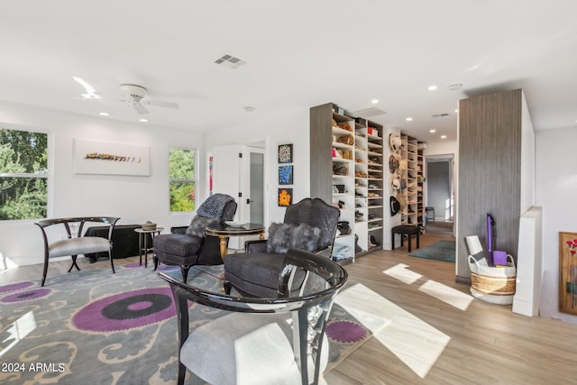 living room featuring ceiling fan and light wood-type flooring