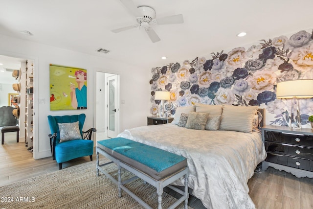 bedroom with ceiling fan and light hardwood / wood-style flooring