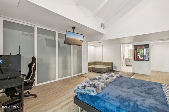 bedroom with high vaulted ceiling, light wood-type flooring, and beamed ceiling