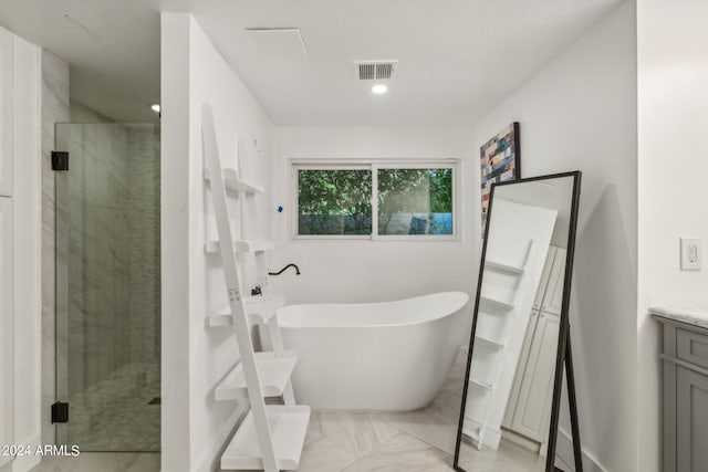 bathroom featuring vanity and independent shower and bath