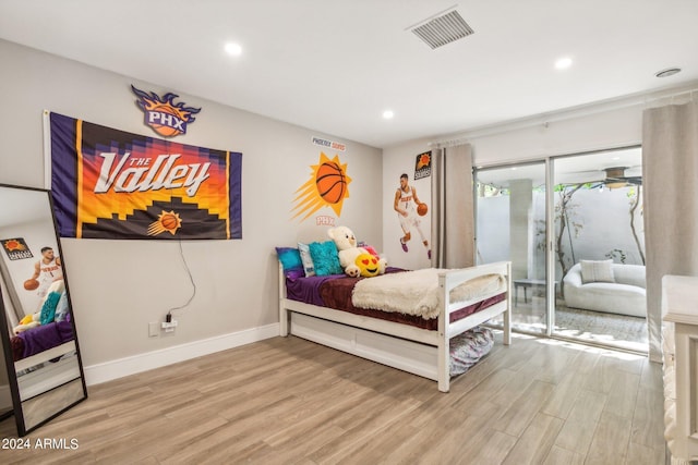 bedroom featuring light wood-type flooring and access to exterior