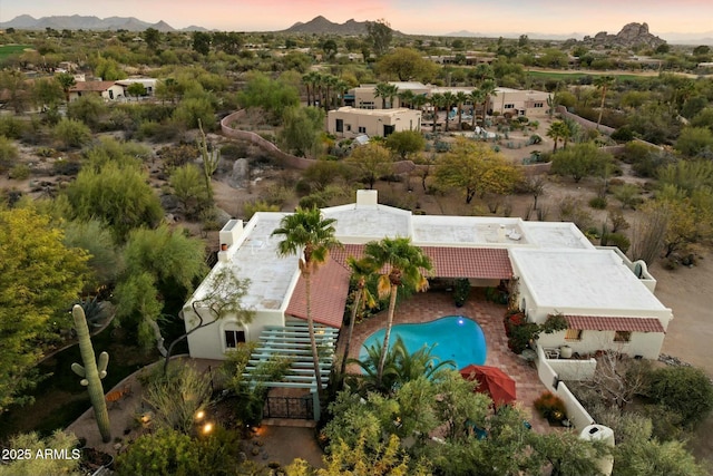 aerial view at dusk featuring a mountain view