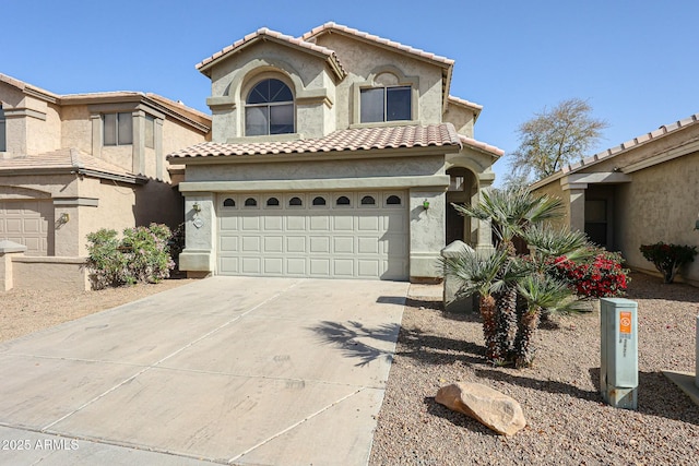 mediterranean / spanish home featuring a garage, driveway, a tile roof, and stucco siding