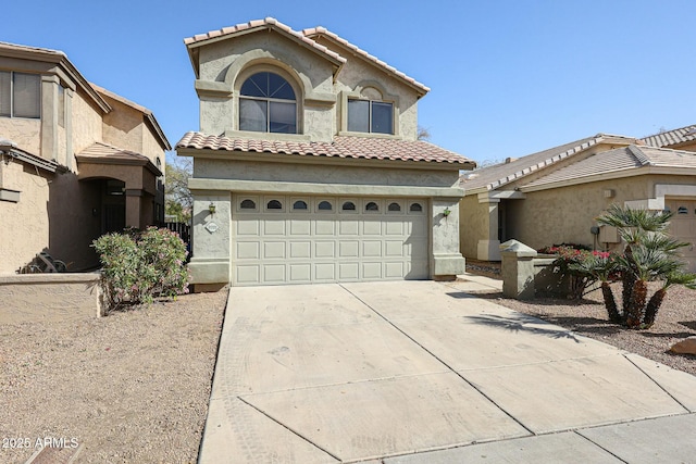 mediterranean / spanish house with a garage, concrete driveway, a tile roof, and stucco siding