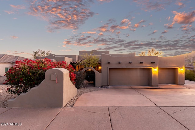 pueblo-style house with a garage