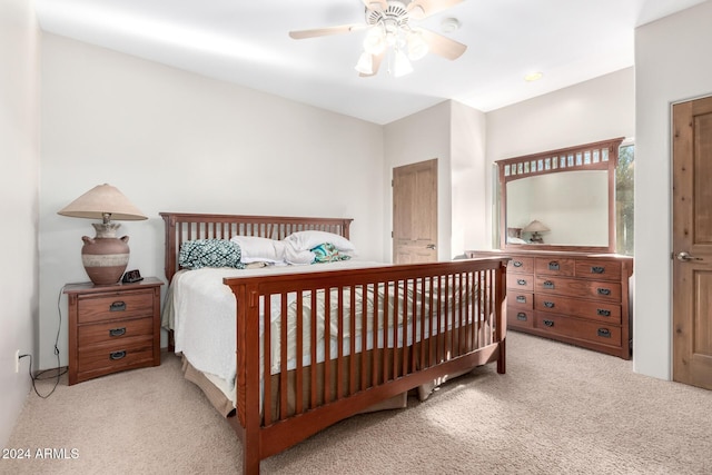 bedroom with ceiling fan and light carpet