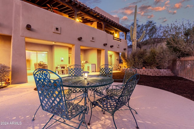 view of patio terrace at dusk