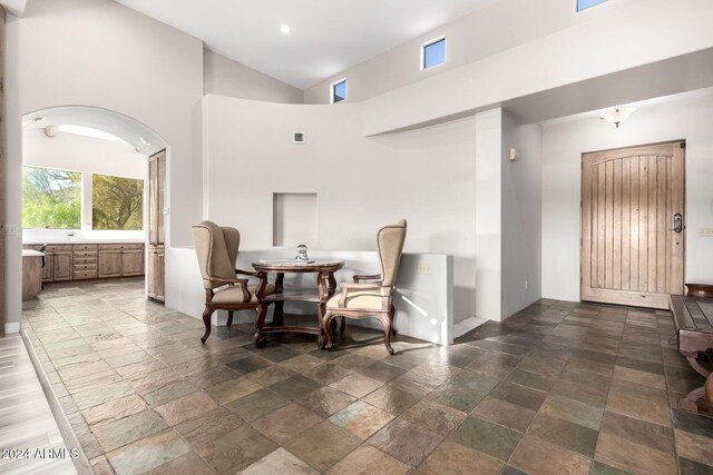 living area featuring a towering ceiling