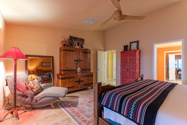 tiled bedroom with ceiling fan and lofted ceiling