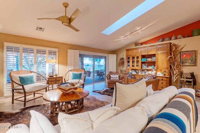 living room with ceiling fan and lofted ceiling with skylight