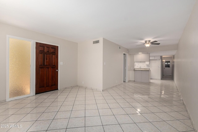 6818 N 35th Ave Unit C, Phoenix, AZ 85017 - unfurnished living room with a ceiling fan, light tile patterned floors, and baseboards