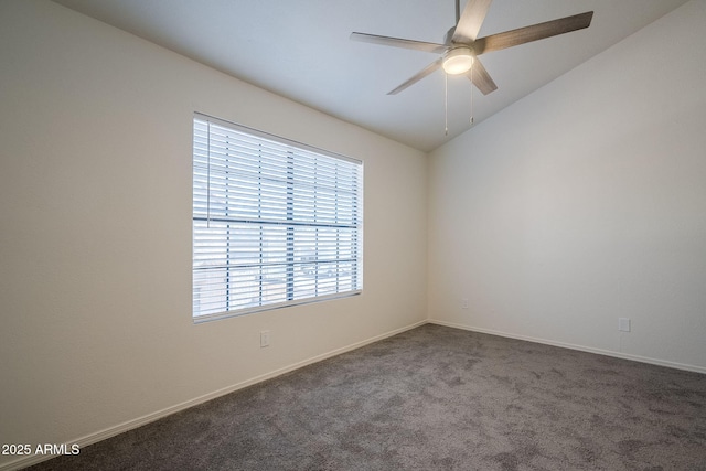 carpeted spare room featuring ceiling fan and lofted ceiling