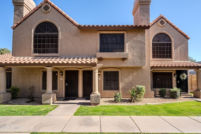 mediterranean / spanish home featuring covered porch