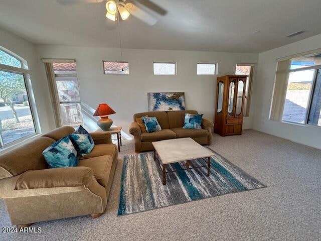 living room featuring carpet floors, plenty of natural light, and ceiling fan