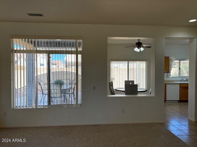 spare room with ceiling fan and tile patterned floors