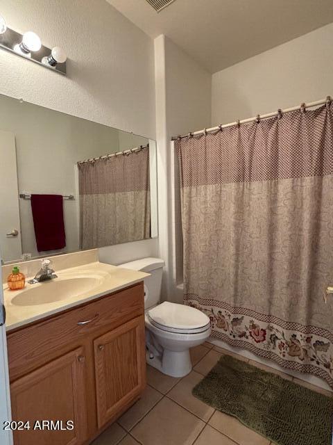 bathroom with vanity, toilet, tile patterned flooring, and a shower with shower curtain