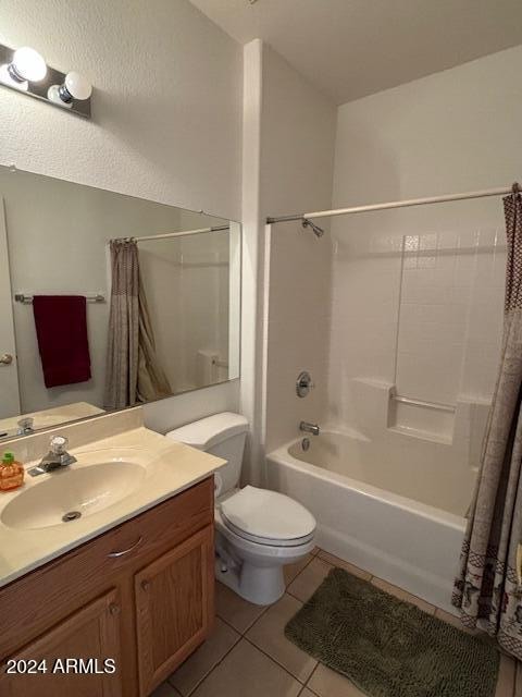 full bathroom with vanity, shower / bath combination with curtain, toilet, and tile patterned floors