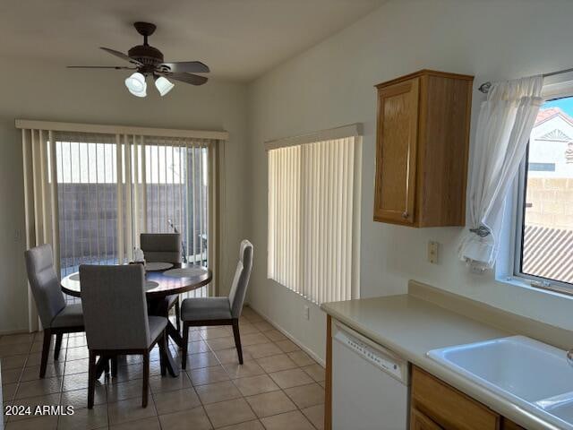 tiled dining space with sink and ceiling fan