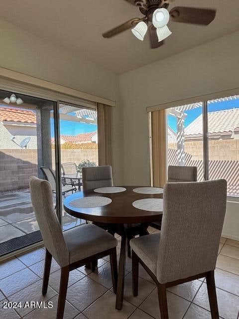 dining room with tile patterned floors, plenty of natural light, and ceiling fan