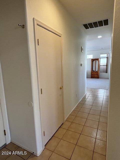 hall with light tile patterned floors