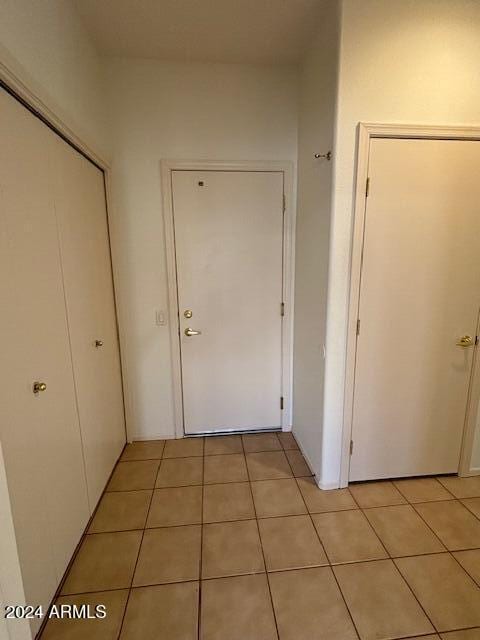 hallway featuring light tile patterned flooring