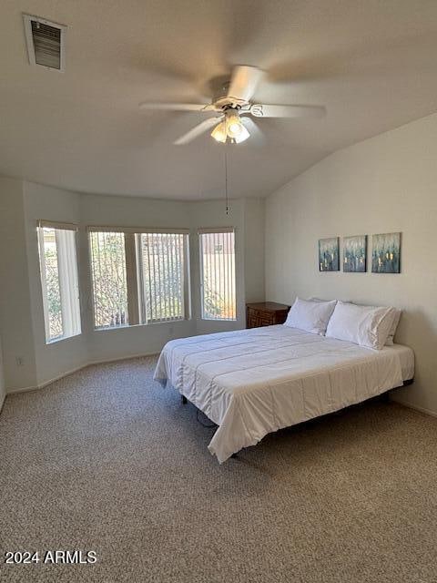 bedroom with lofted ceiling, carpet flooring, and ceiling fan