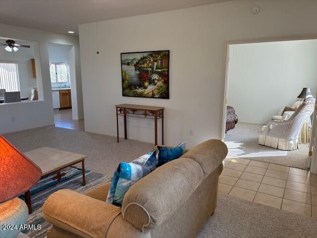 tiled living room with ceiling fan