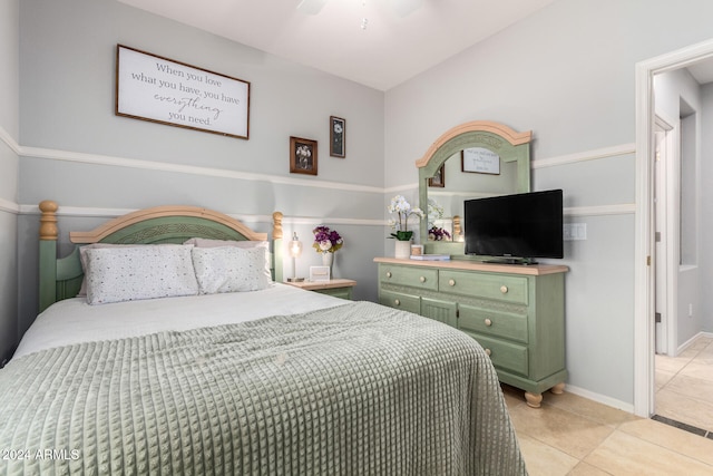 tiled bedroom featuring ceiling fan