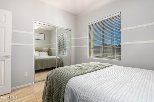 tiled bedroom featuring a closet