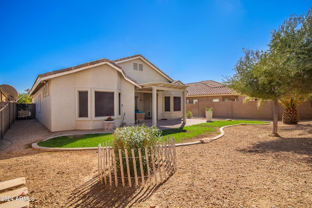 rear view of property featuring a patio area