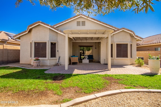 rear view of property featuring a pergola, a patio area, and a yard