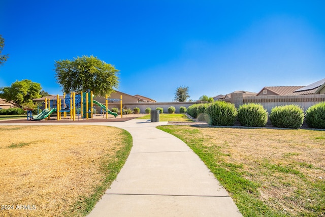 surrounding community with a yard and a playground