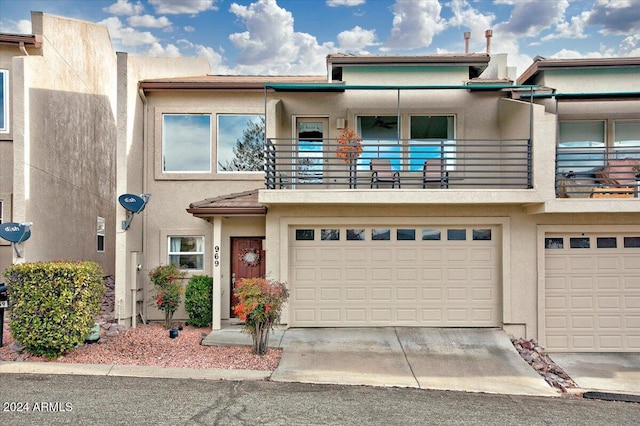 view of property featuring a garage and a balcony