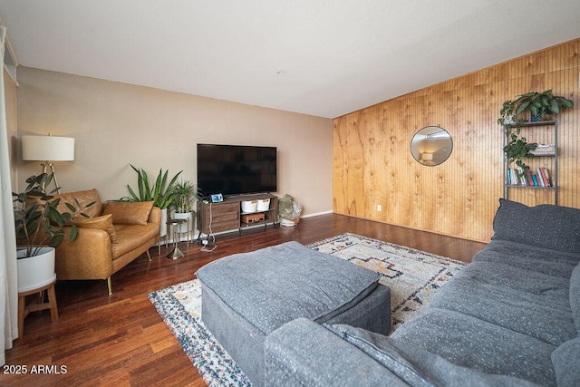living area with wooden walls and wood finished floors