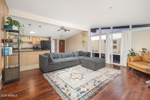 living area featuring dark wood finished floors, a ceiling fan, and floor to ceiling windows