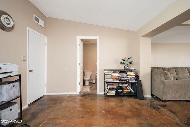 office with concrete flooring, baseboards, and vaulted ceiling