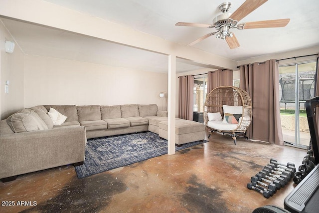 living room with ceiling fan and concrete floors