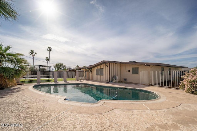 view of pool with fence and a patio