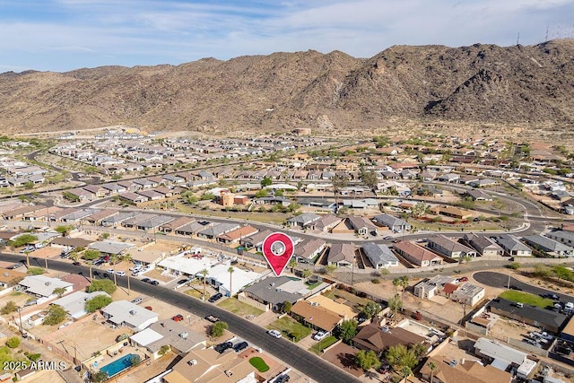 aerial view of property and surrounding area with nearby suburban area and mountains