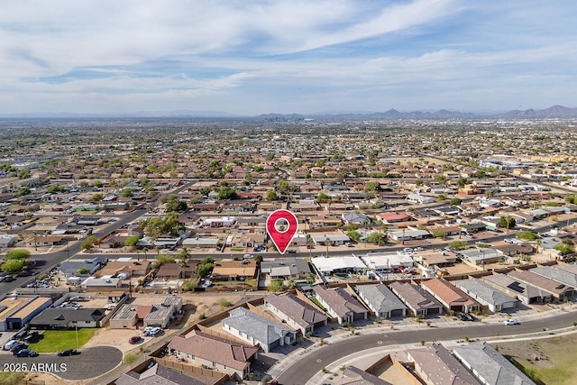 aerial overview of property's location featuring a mountain backdrop and nearby suburban area