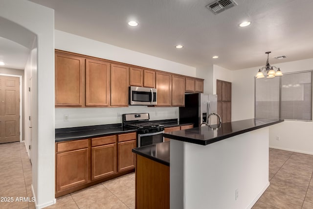 8848 W Cordes Rd, Tolleson, AZ 85353 - kitchen featuring stainless steel appliances, dark countertops, light tile patterned flooring, a chandelier, and recessed lighting