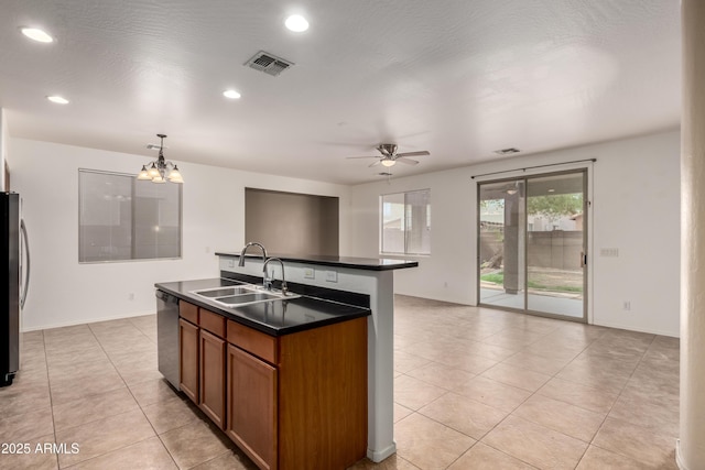8848 W Cordes Rd, Tolleson, AZ 85353 - kitchen featuring a sink, dark countertops, brown cabinetry, appliances with stainless steel finishes, and ceiling fan