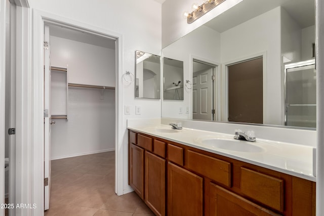 8848 W Cordes Rd, Tolleson, AZ 85353 - bathroom with double vanity, tile patterned flooring, a walk in closet, and a shower with shower door
