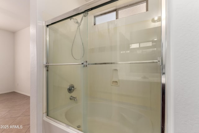 8848 W Cordes Rd, Tolleson, AZ 85353 - full bath featuring combined bath / shower with glass door, tile patterned flooring, a textured wall, and baseboards