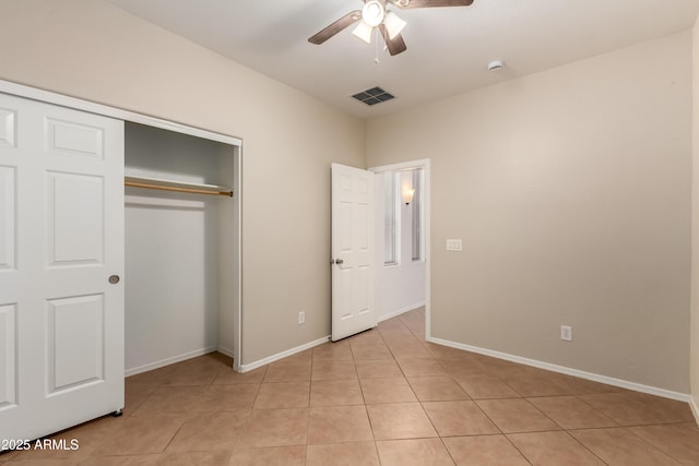 8848 W Cordes Rd, Tolleson, AZ 85353 - unfurnished bedroom with a closet, baseboards, and light tile patterned floors