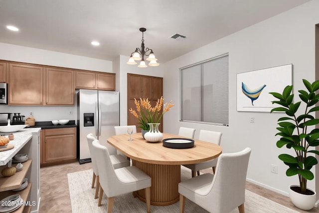 8848 W Cordes Rd, Tolleson, AZ 85353 - dining area featuring a chandelier, recessed lighting, and baseboards