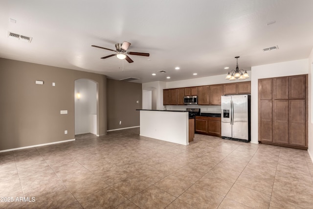 8848 W Cordes Rd, Tolleson, AZ 85353 - kitchen with appliances with stainless steel finishes, arched walkways, dark countertops, ceiling fan, and a chandelier
