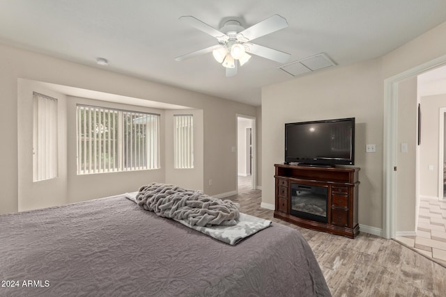 bedroom with ceiling fan and light hardwood / wood-style flooring